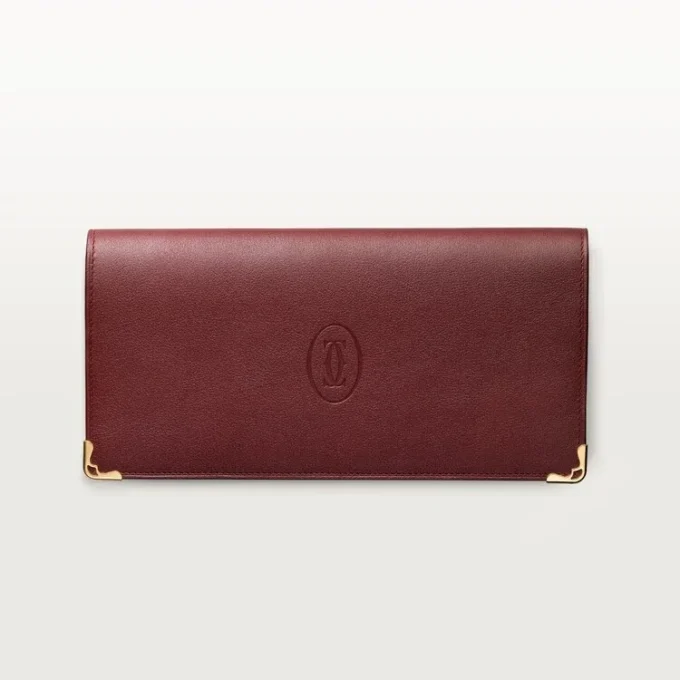 Billetera internacional con fuelles, Must de Cartier – Piel de becerro color burdeos, acabado dorado – Cartier Billetera internacional con fuelles, Must de Cartier – Piel de becerro color burdeos, acabado dorado – Cartier