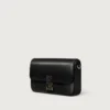 Bolso de cadena mini, Double C de Cartier – Piel de becerro negra, acabado en esmalte dorado y negro – Cartier Bolso de cadena mini, Double C de Cartier – Piel de becerro negra, acabado en esmalte dorado y negro – Cartier