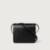Bolso de hombro, Mini, Double C De Cartier – Piel de becerro negra, acabado en esmalte dorado y negro – Cartier Bolso de hombro, Mini, Double C De Cartier – Piel de becerro negra, acabado en esmalte dorado y negro – Cartier